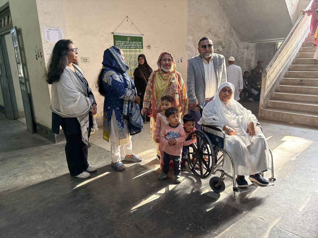 An 86 year old woman goes to Dhanmondi Government Girls High School with her family. She has not voted in 17 years.